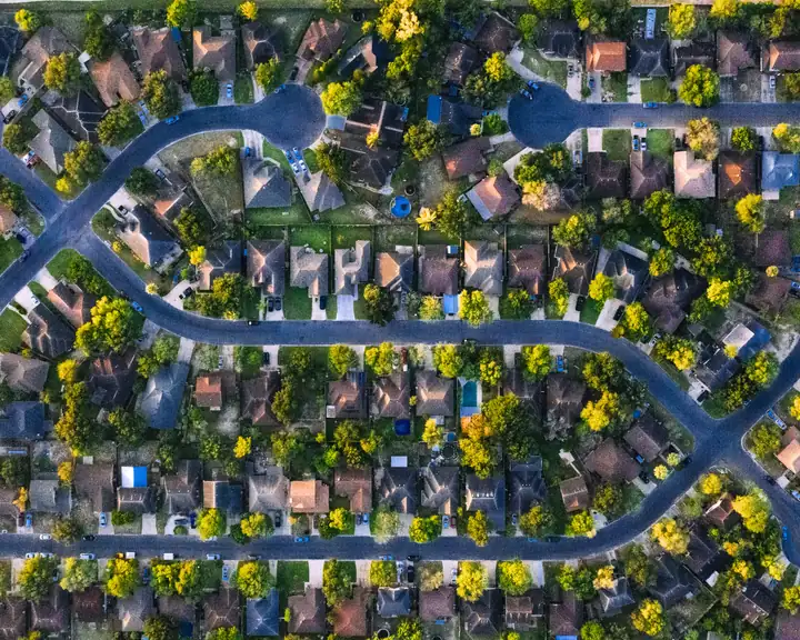 Aerial view of homes along tree-lined neighborhood streets